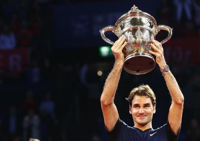 Switzerland's Roger Federer holds the trophy after winning his match against Rafael Nadal of Spain at the Swiss Indoors ATP men's tennis tournament in Basel, Switzerland November 1, 2015.   REUTERS/Arnd Wiegmann