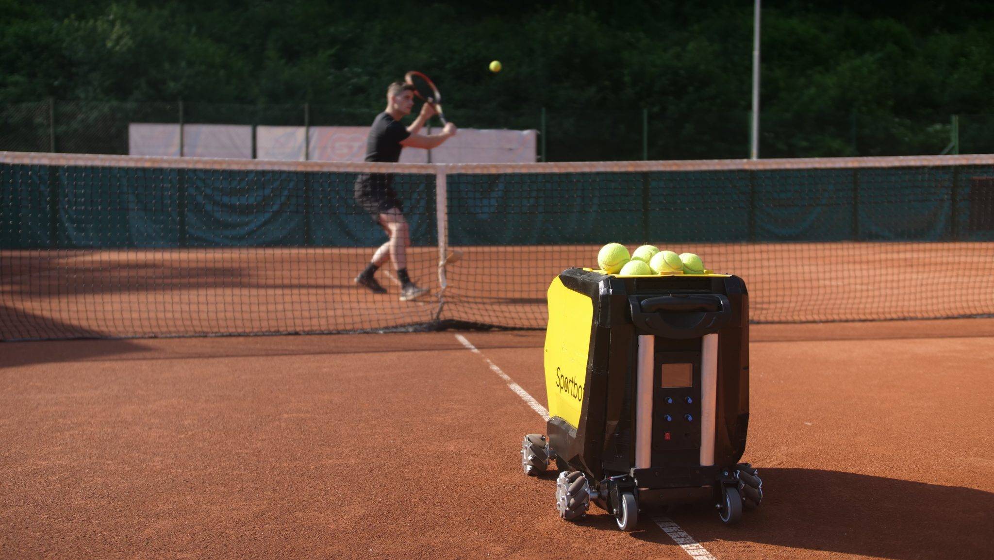 Sportbot a moving tennis ball machine